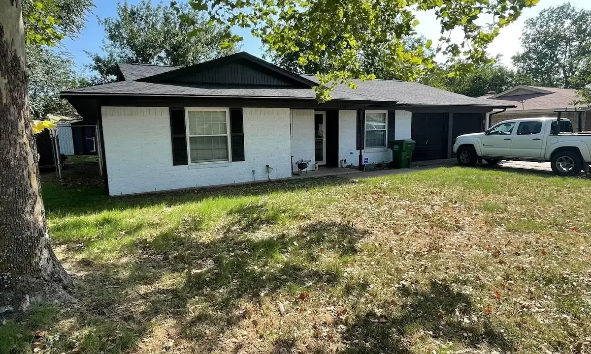 Professional roofing crew working on a residential roof in Kaser